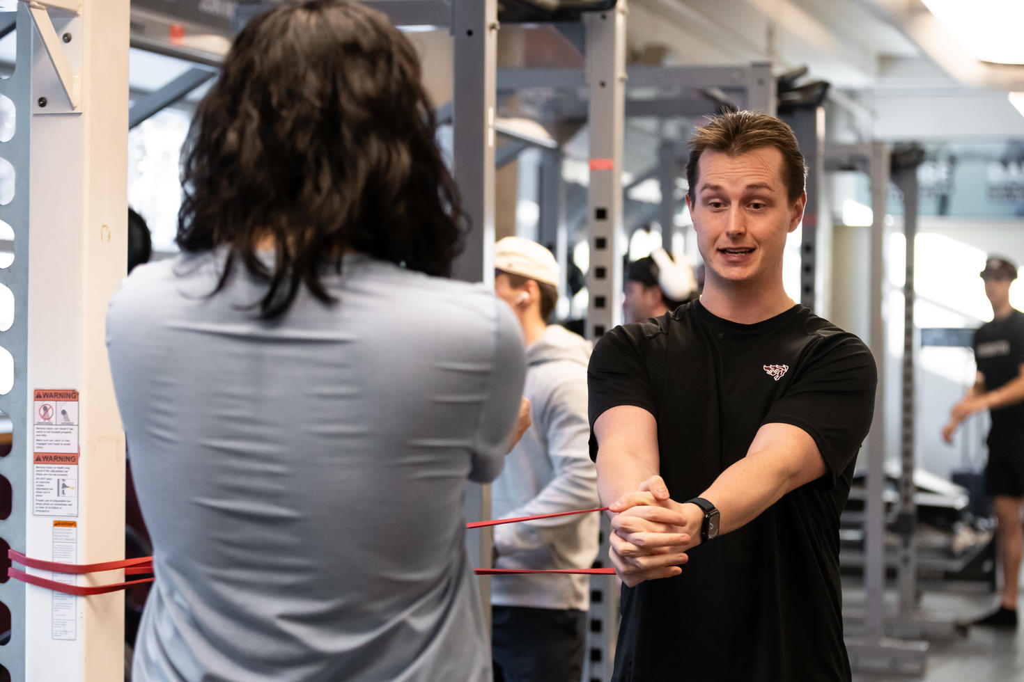 Fitness trainer showing a person what to do