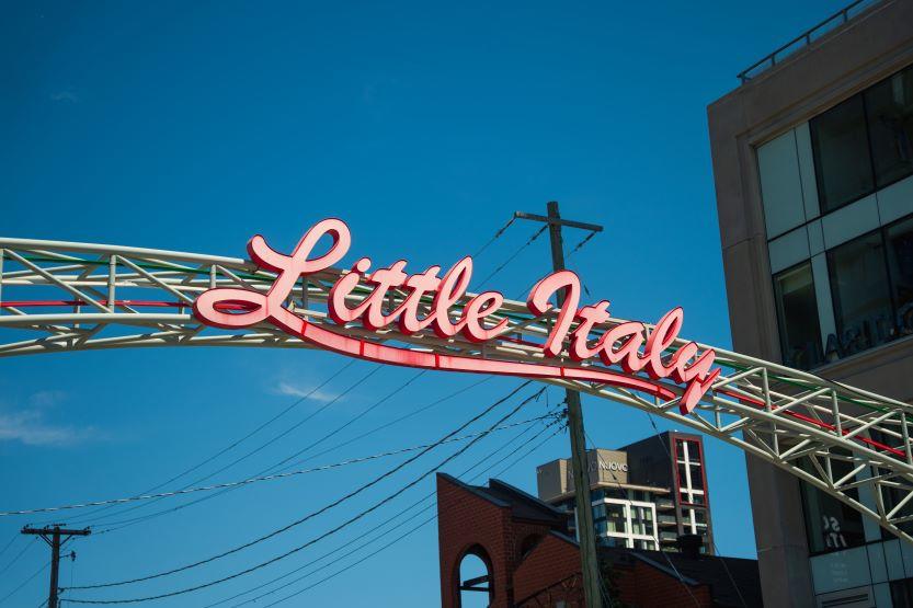 A metallic arch with the words Little Italy in cursive letters