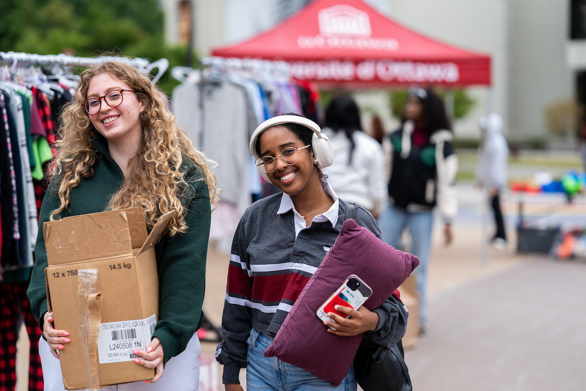 Two students walk away from the Free Store with items they found