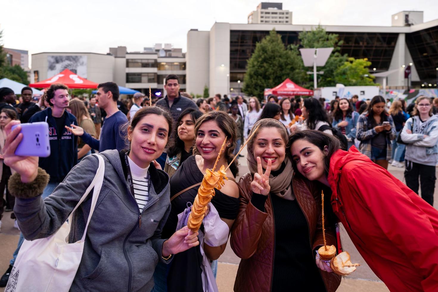 Four students enjoy a fried potato snack during Welcome Week in 2025 at the University of Ottawa.