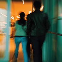 blurred image of an person walking in building