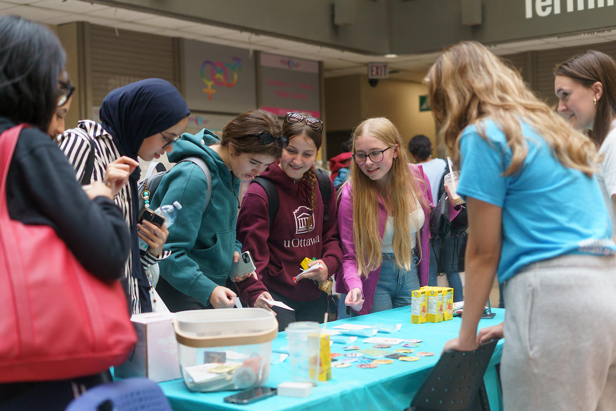 Students around a table talking 