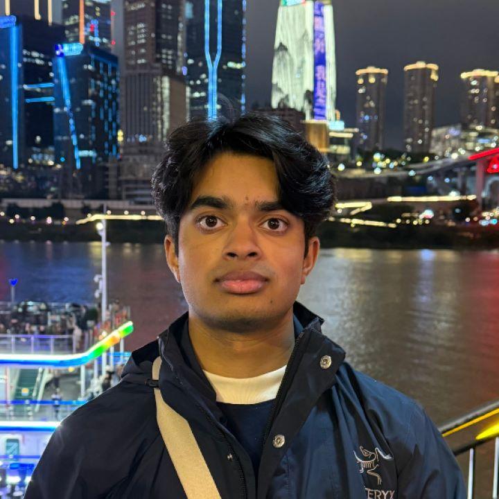 Reuban D’Souza in front of the Singapore skyline at night.