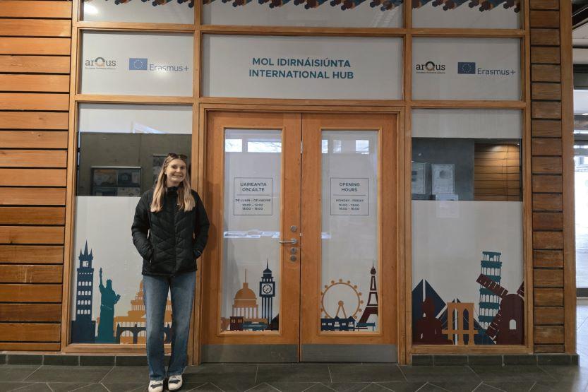 Sarah stands outside an International hub exchange office at Maynooth University, Ireland.