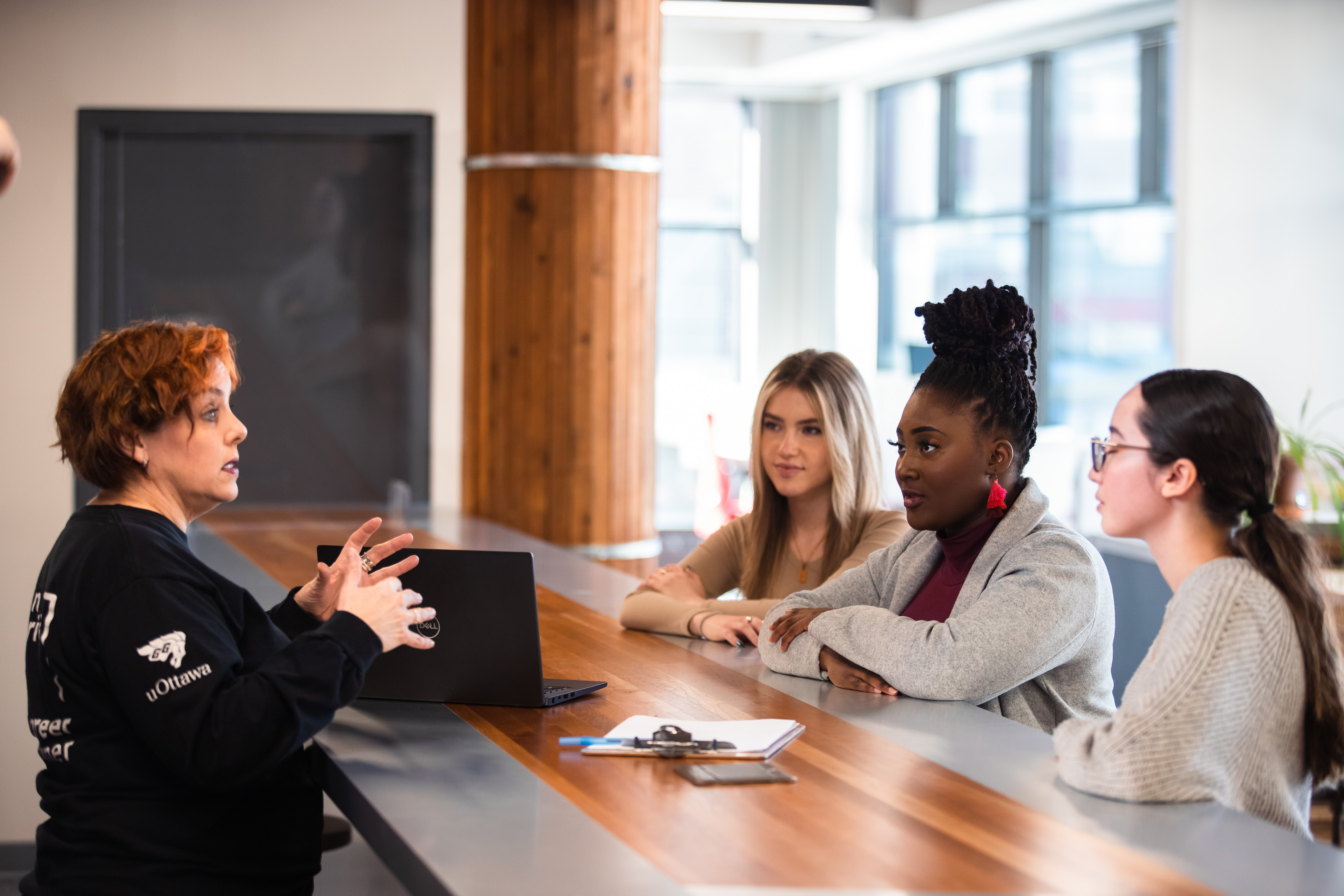 Career Specialist talking to three students