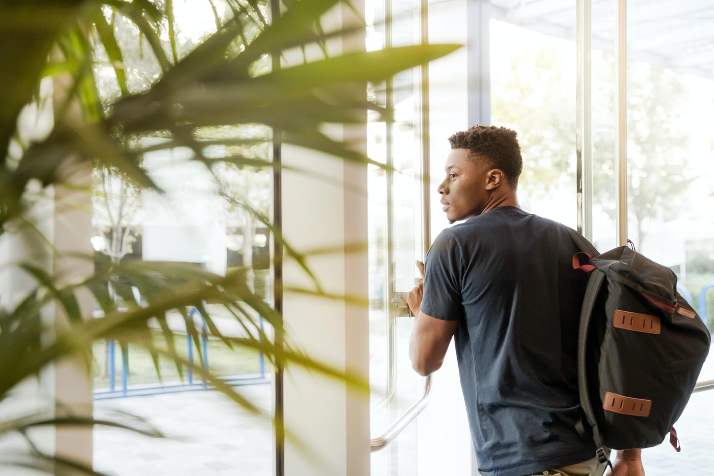 Young man exiting a building 