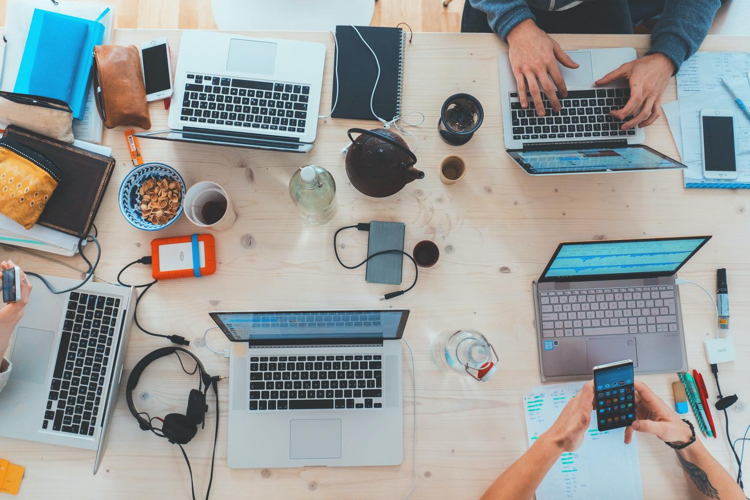 Group of students working on their laptops at a table