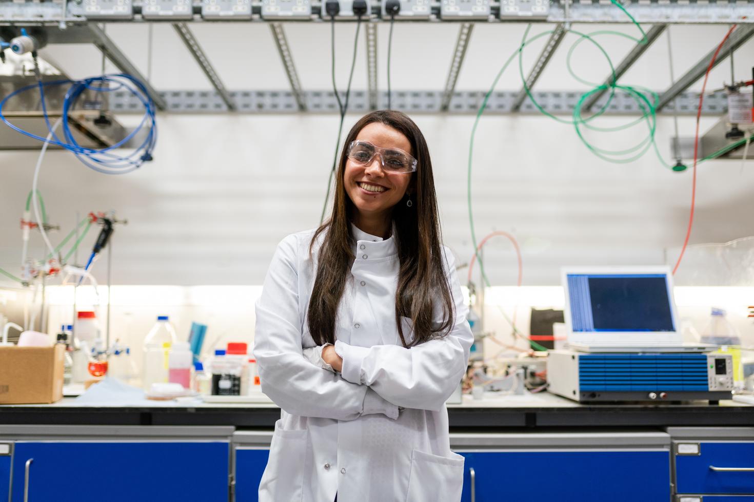 Researcher in a lab smiling