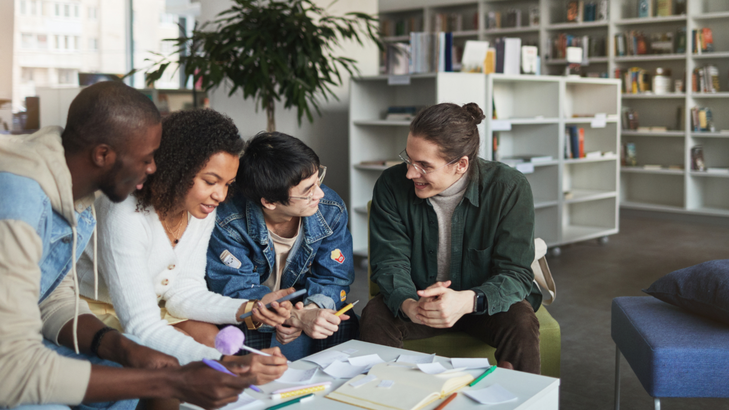 Four students talking and working together