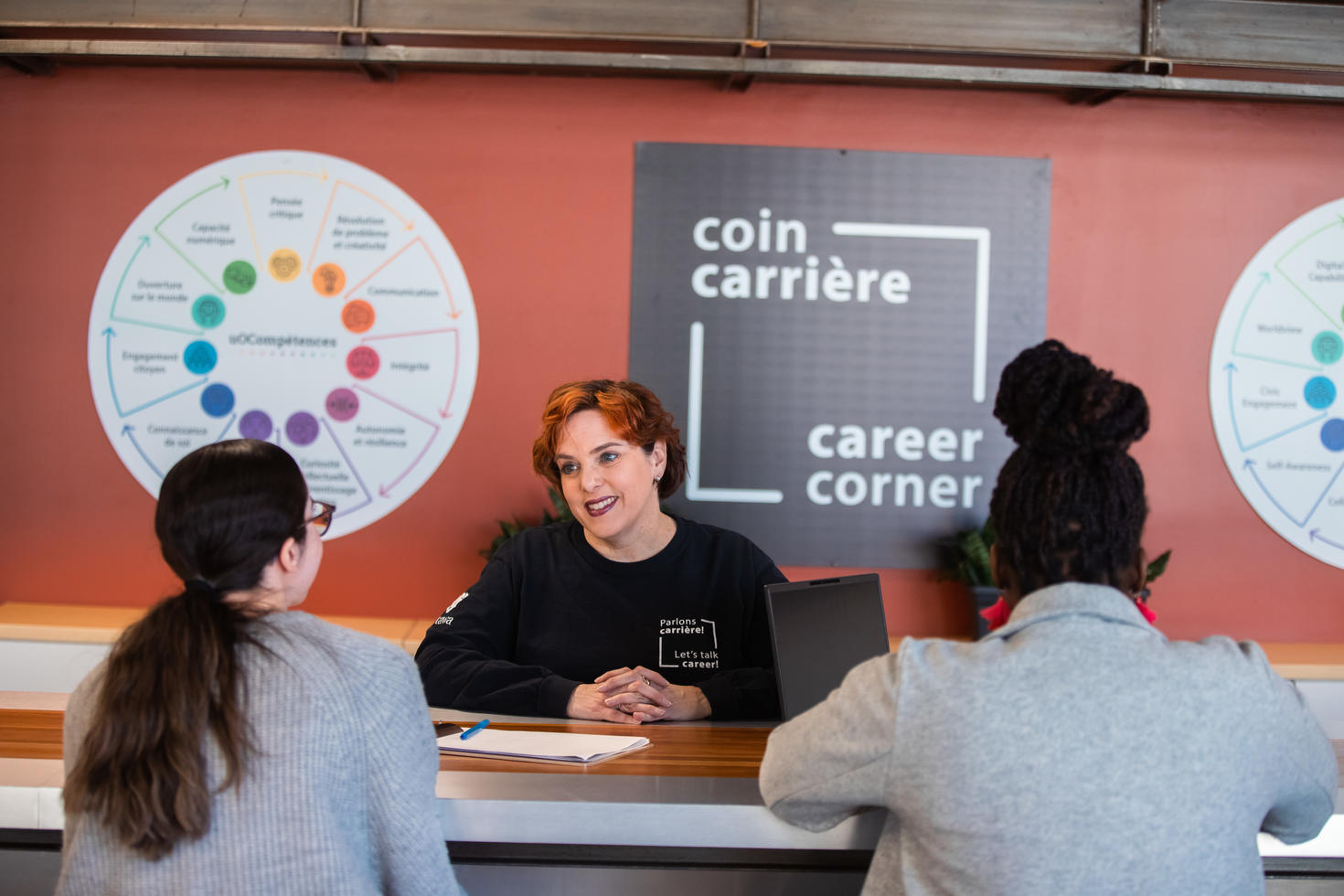 Career Specialist talking to three students