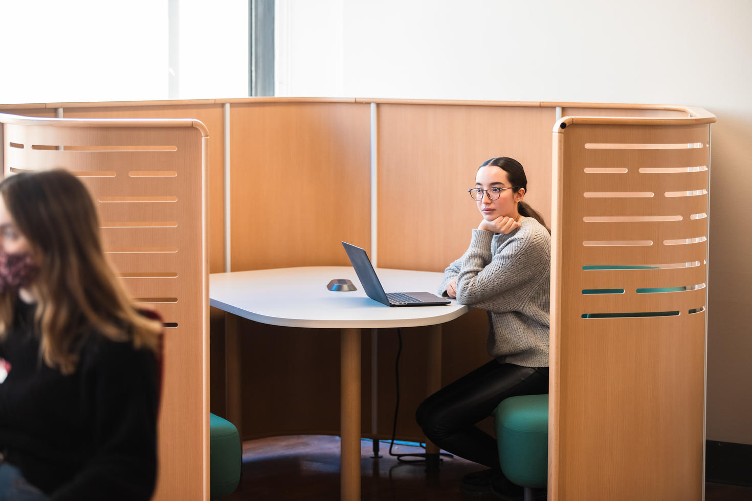 Student sitting at the Career Corner thinking