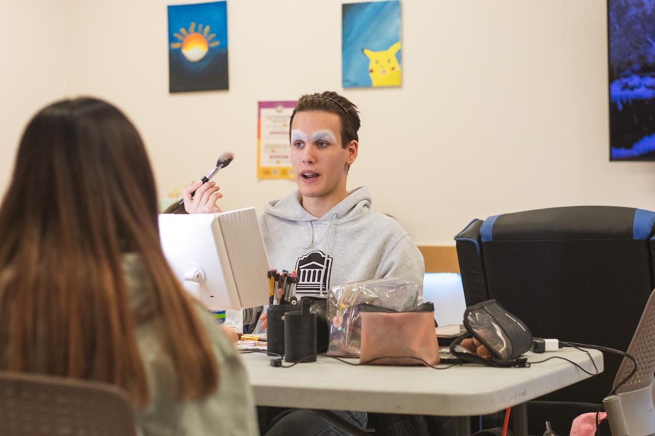 Person teaching how to apply makeup.