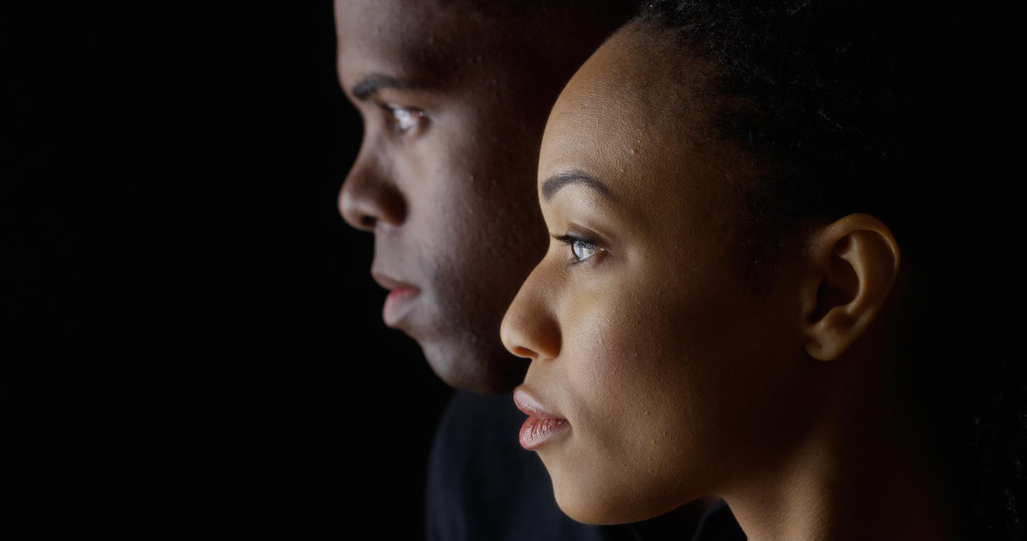 Dramatic side image of two faces: woman and man