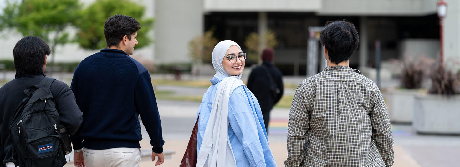 Happy students walking on campus