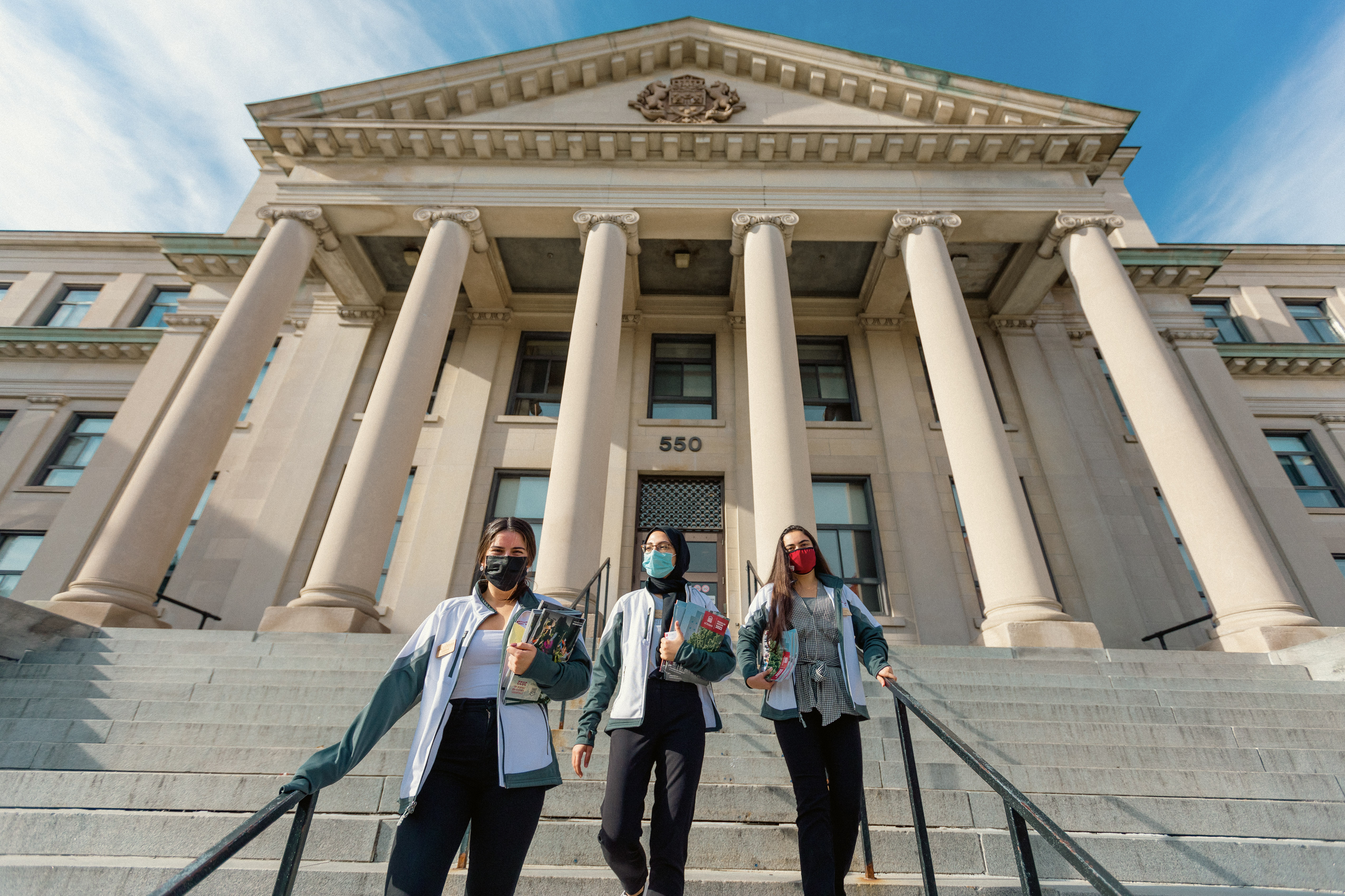 Student ambassadors walking down the steps at Tabaret Hall