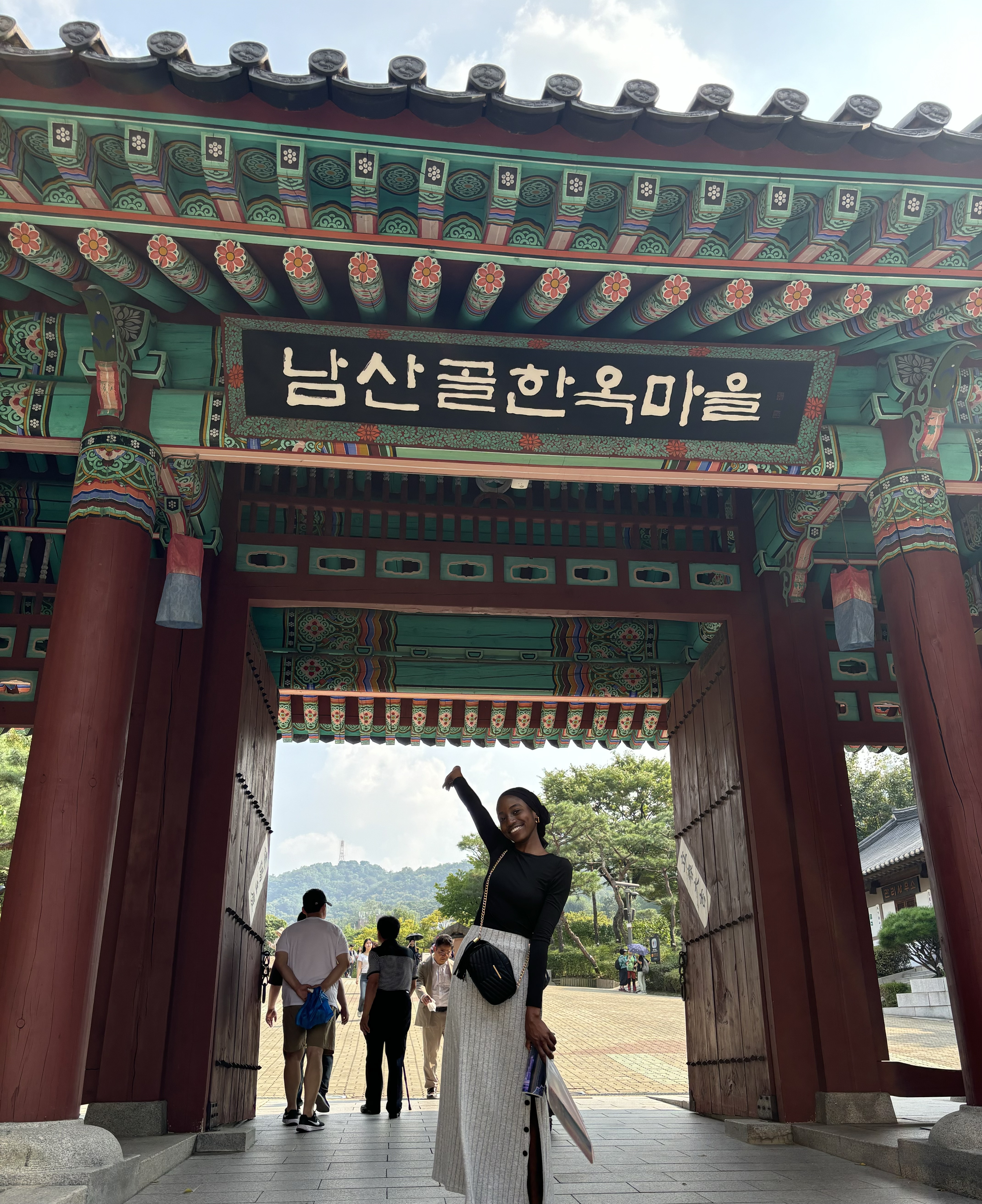 Girl standing in front of a traditional monument in South Korea