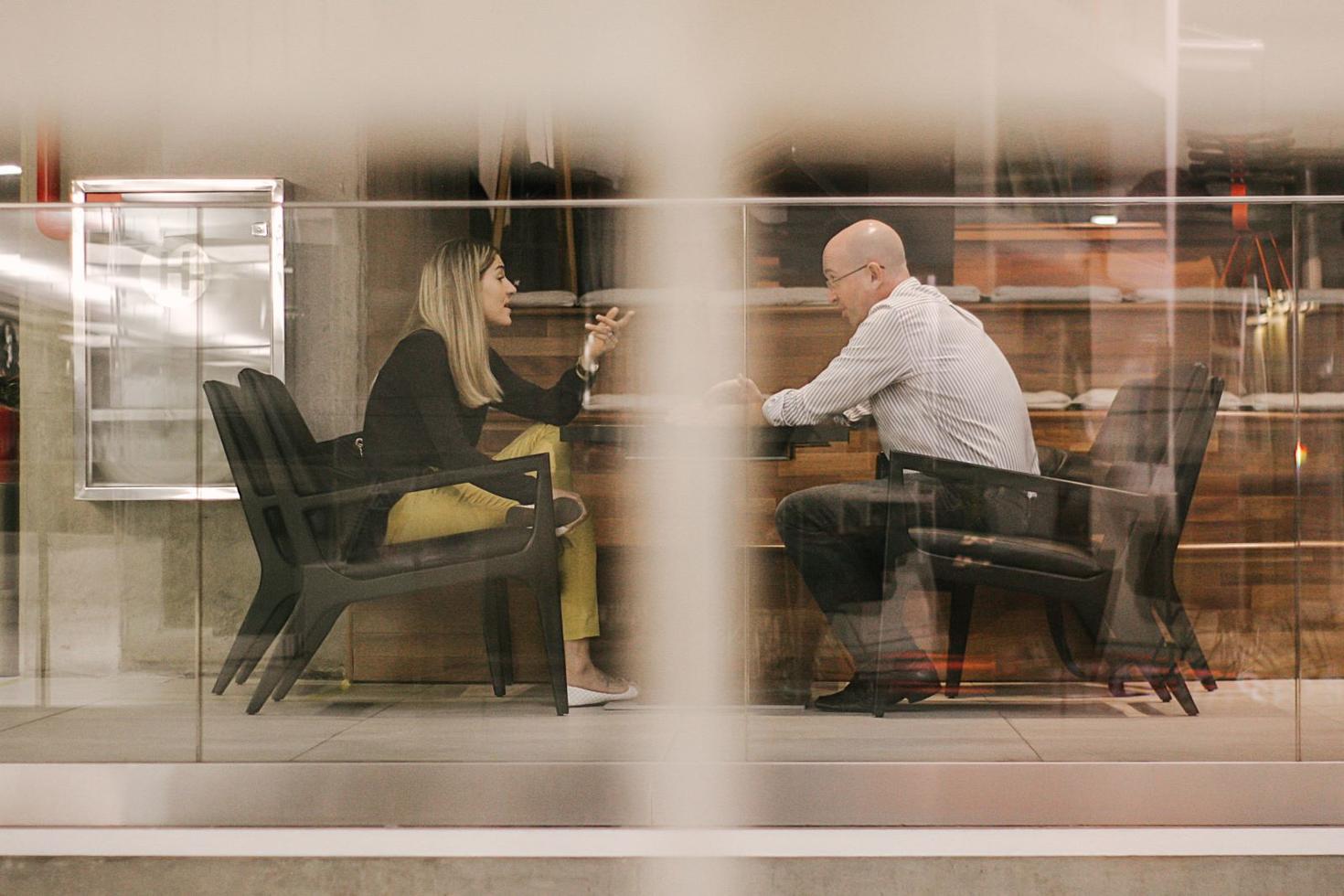 two students sitting at a table discussing