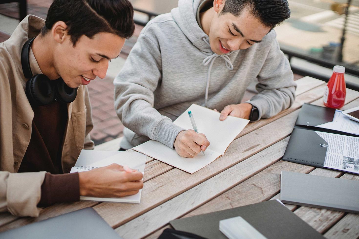 Tow students writing at a table