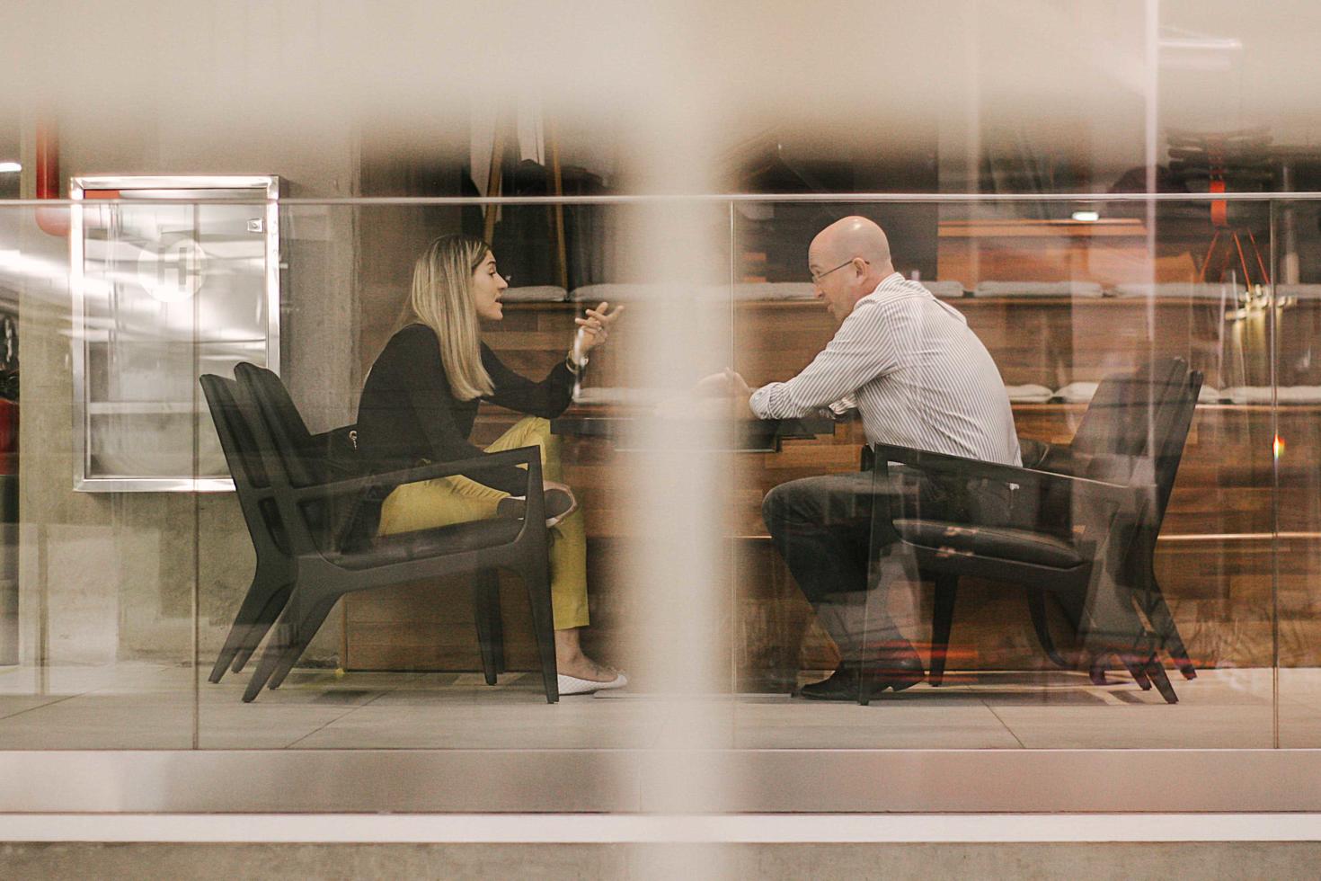 two students sitting at a table discussing