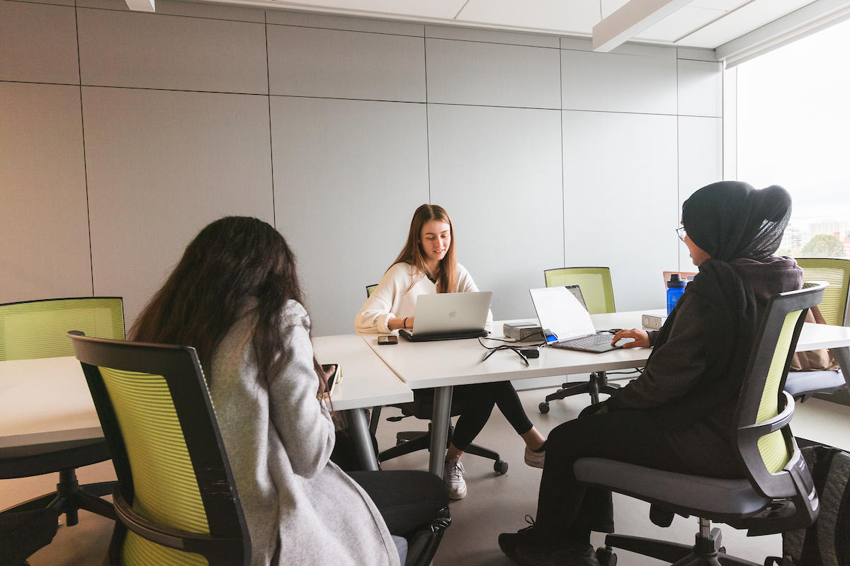 Trois étudiants dans une salle d'étude.