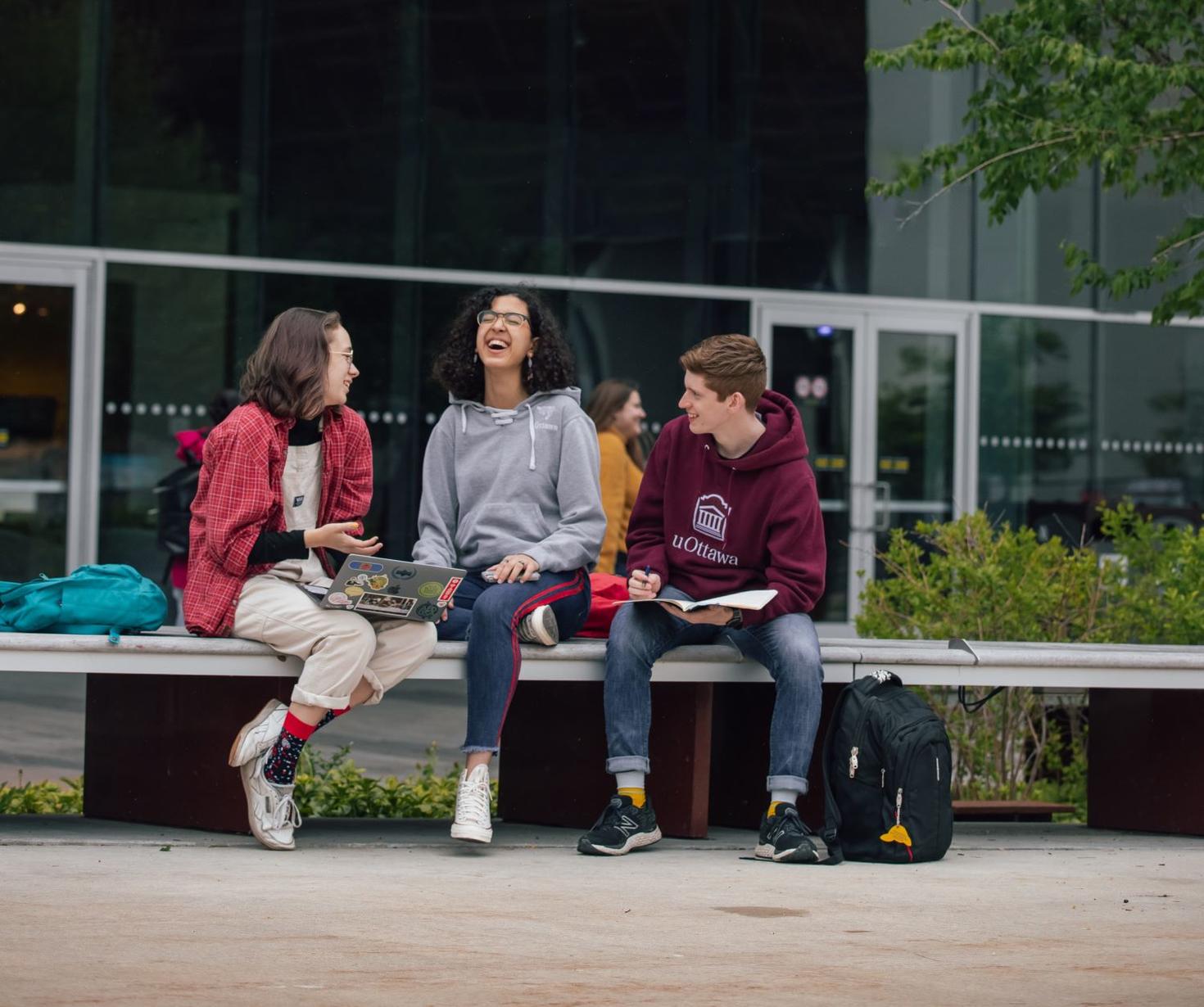 students chatting outside a building
