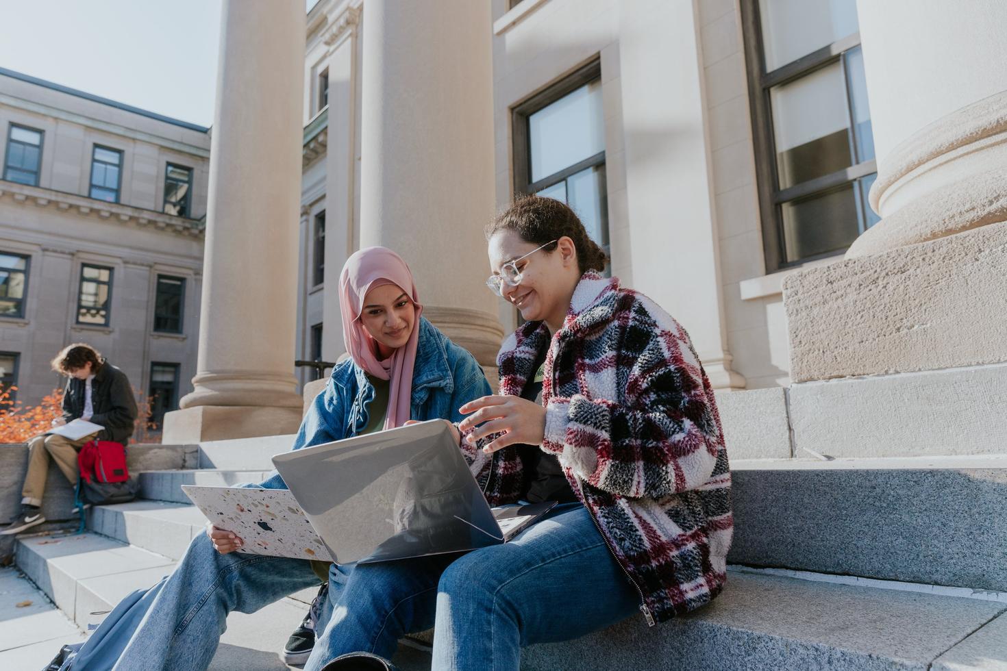 Students sitting on stairs at Tabaret