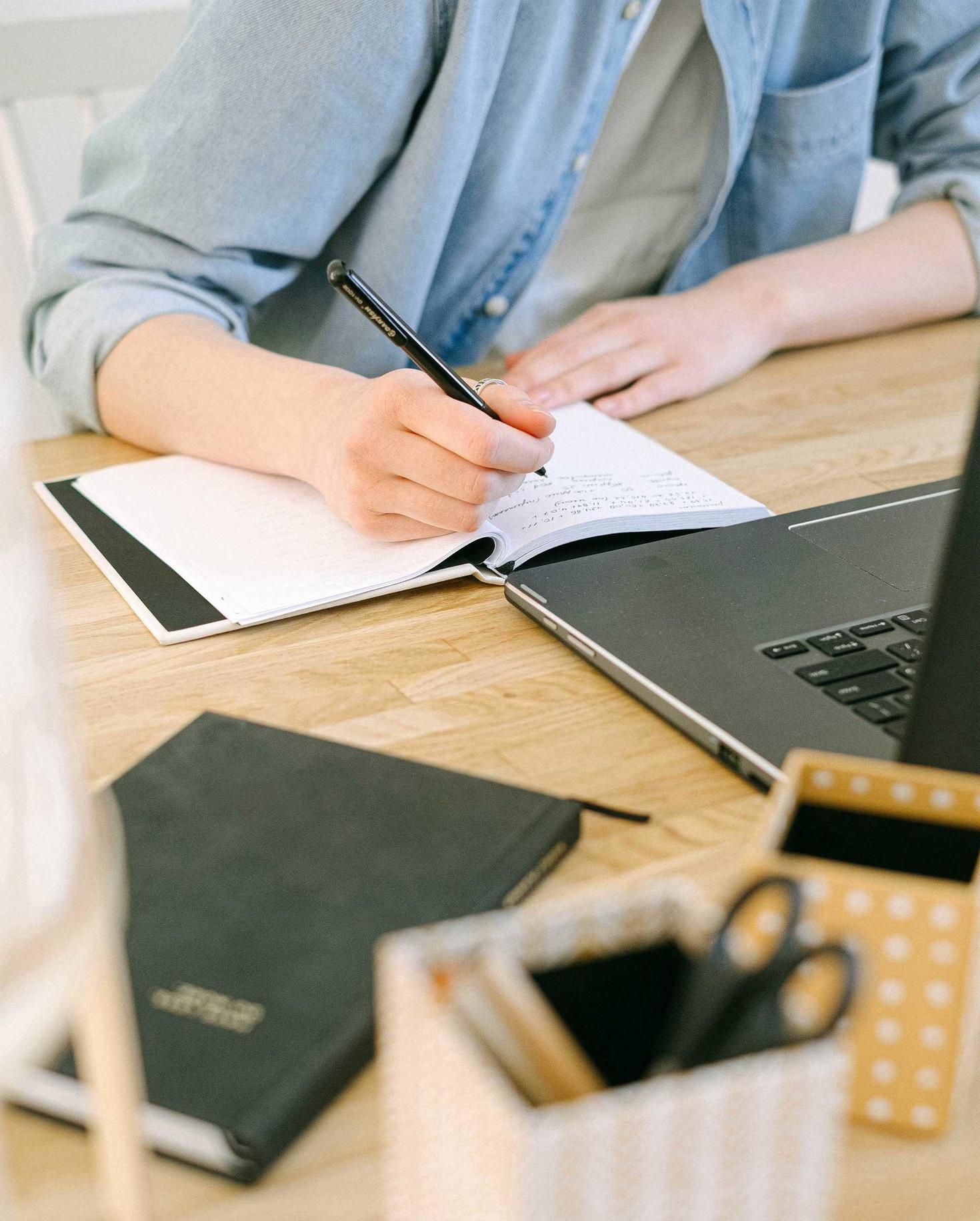 Student writing in notebook