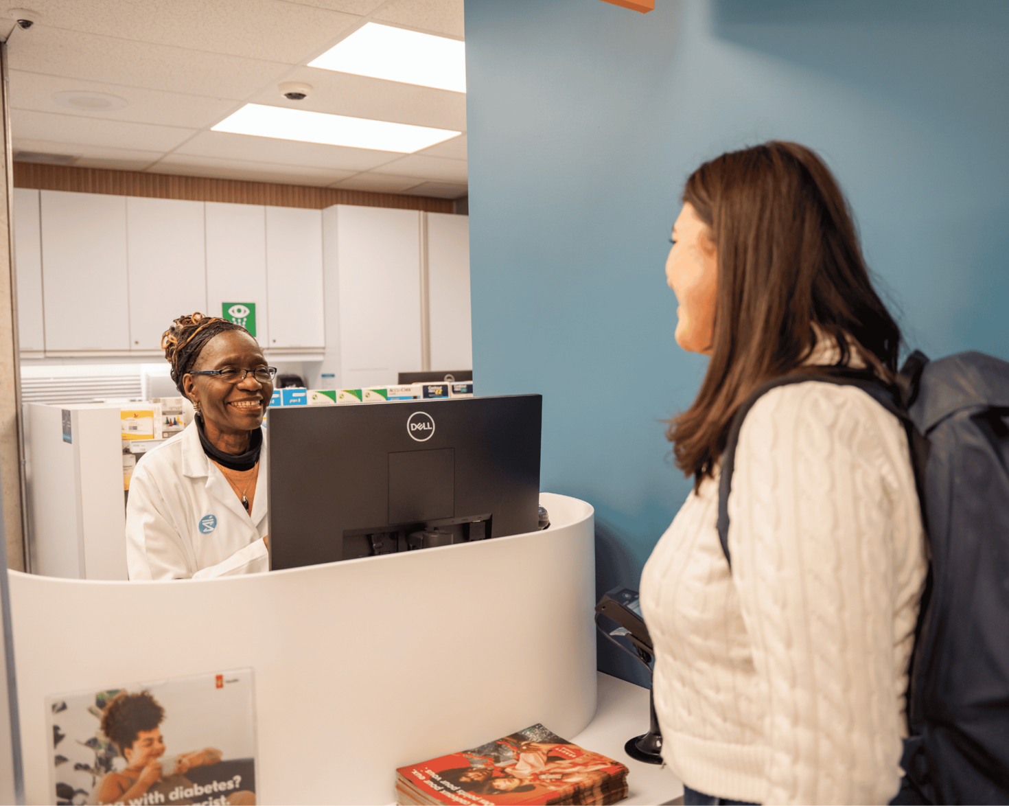 Student smiling at pharmacist in the Student Wellness Centre.