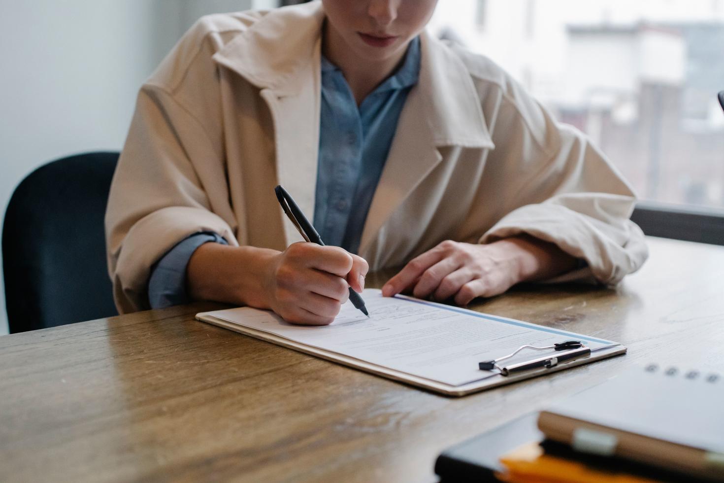 a woman writing her resume