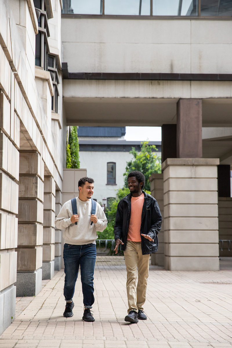 Students walking beside Arts building on campus