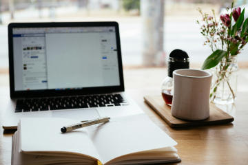 A notebook in front of a laptop