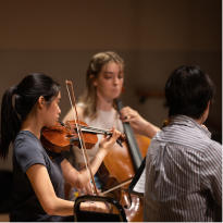 Students playing string instruments
