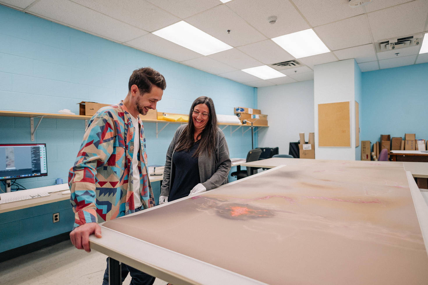 faculty of arts employees working on printing a poster