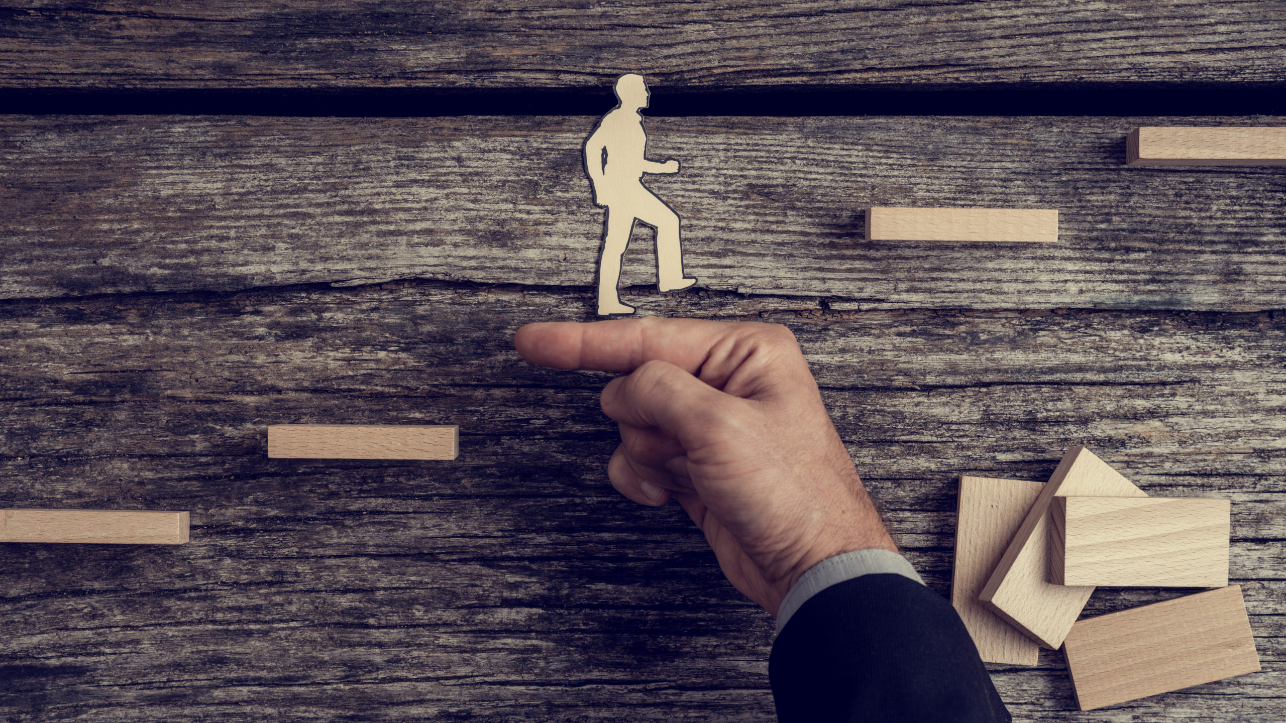 silhouette of person climbing stairs with helping hand