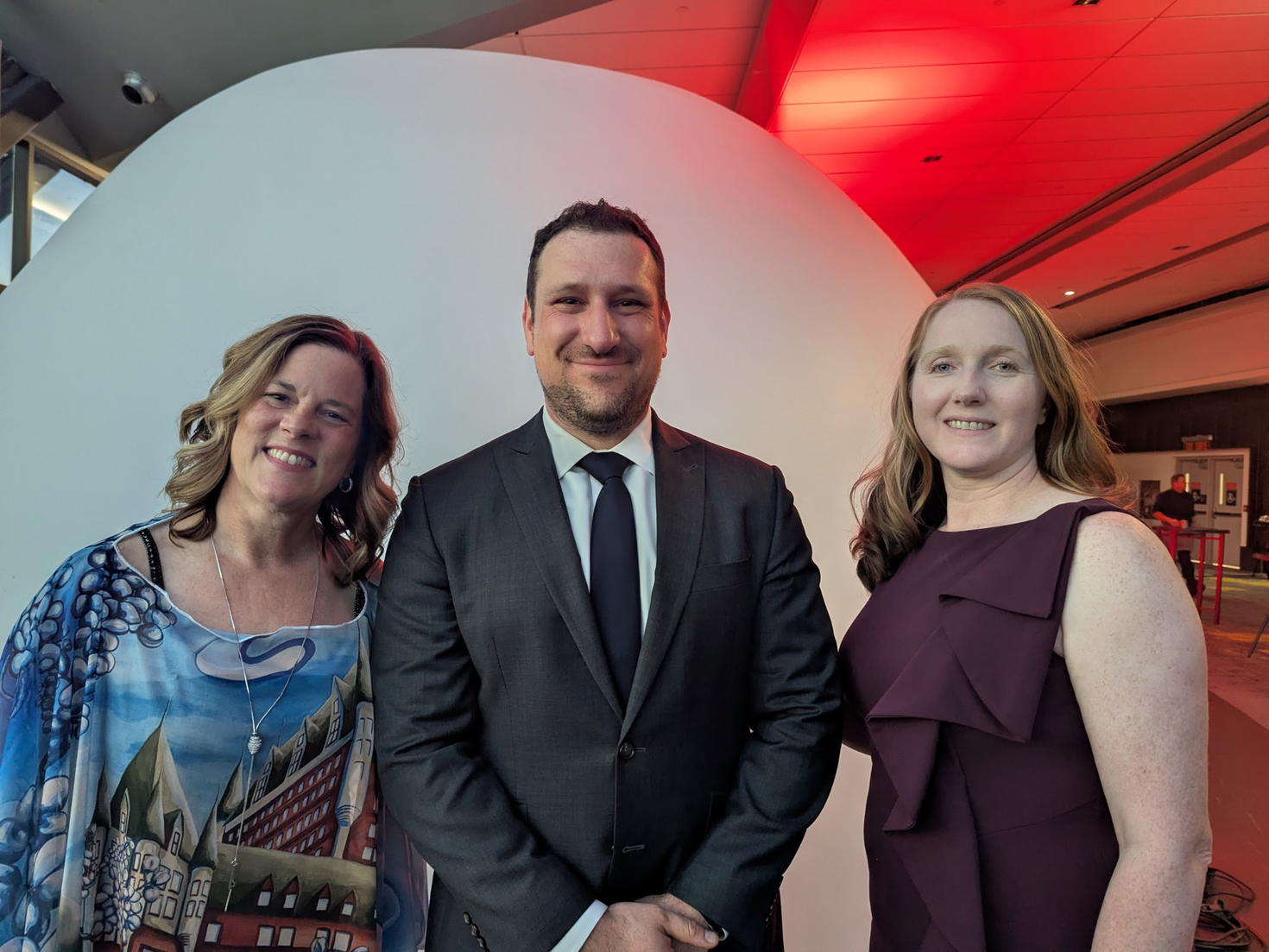 Un homme et deux femmes participantes au gala ont posé