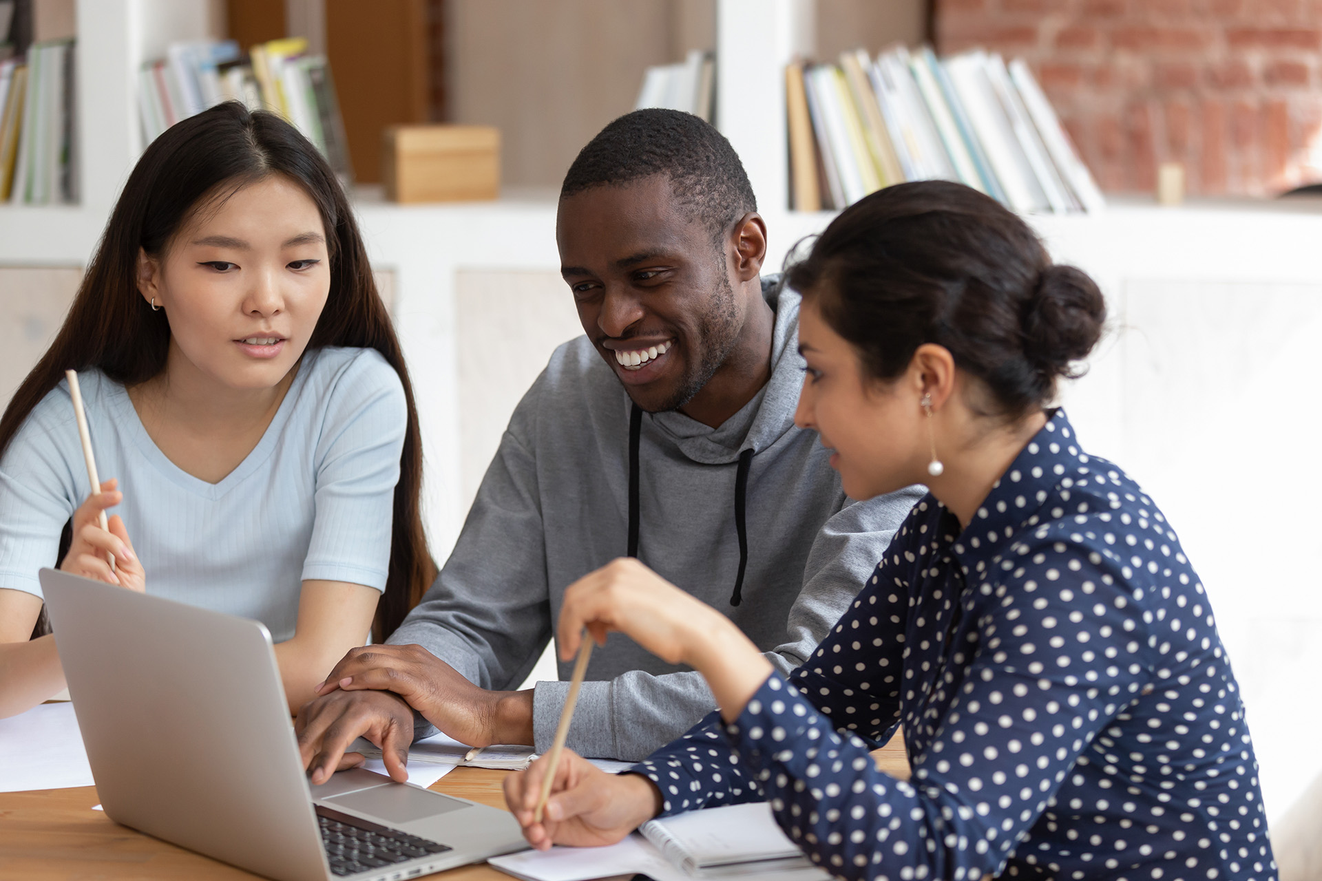 3 students looking at a computer
