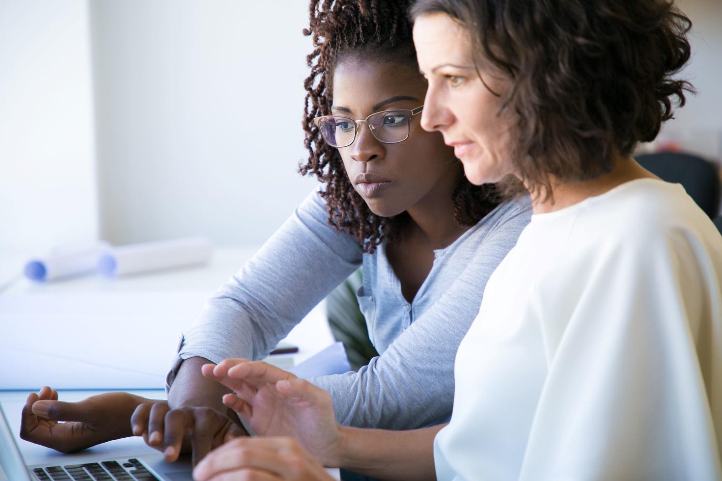 professional woman showing software to a colleague