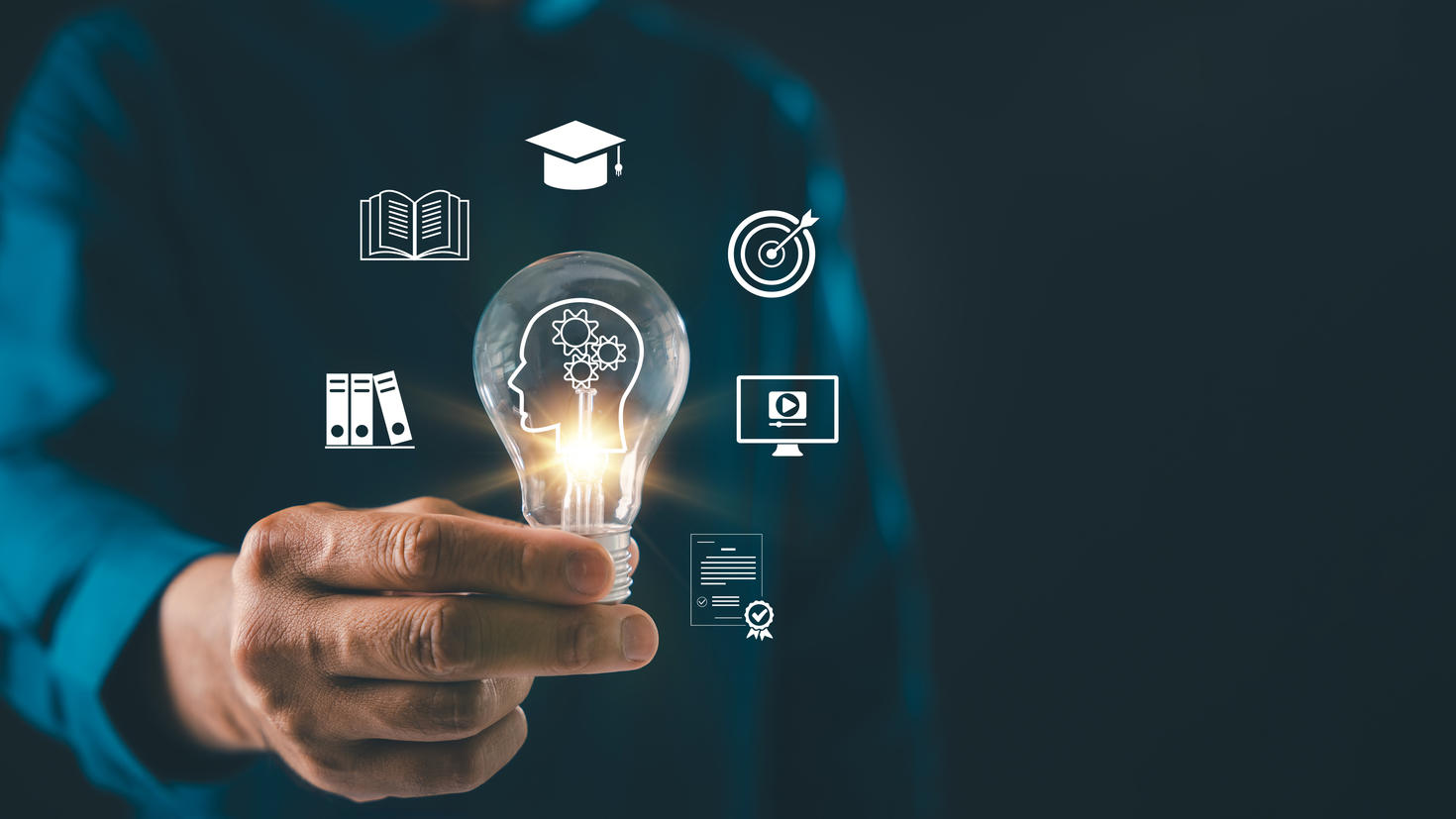 lightbulb graduation study creative idea solution online education icons glow around man hand holding bulb