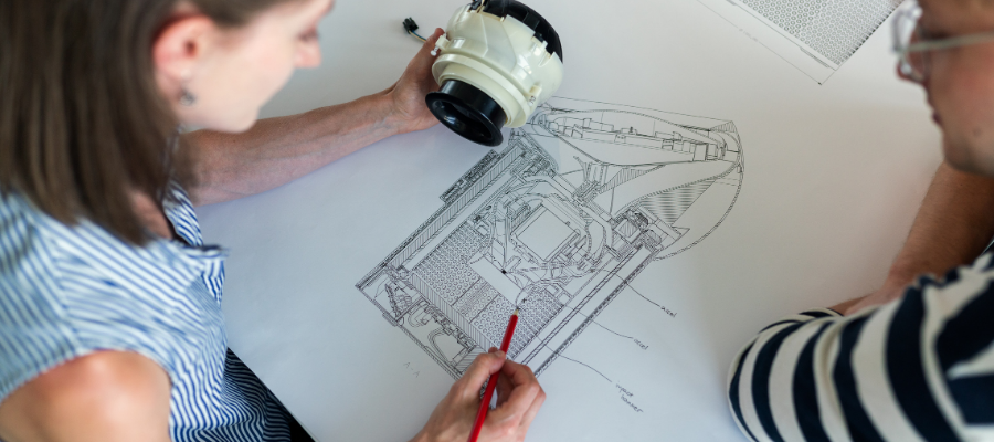 Deux ingénieurs examinent les plans d'une pièce d'équipement.