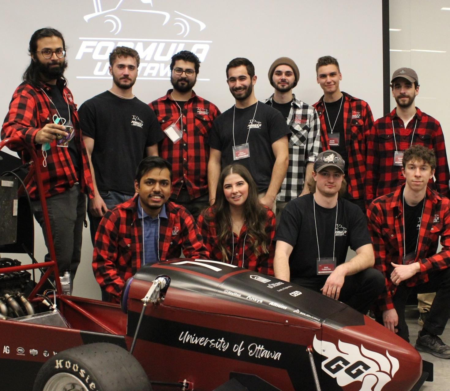 The Formula uOttawa team and their new car.