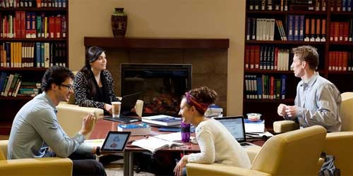 a group of students talking in the hall