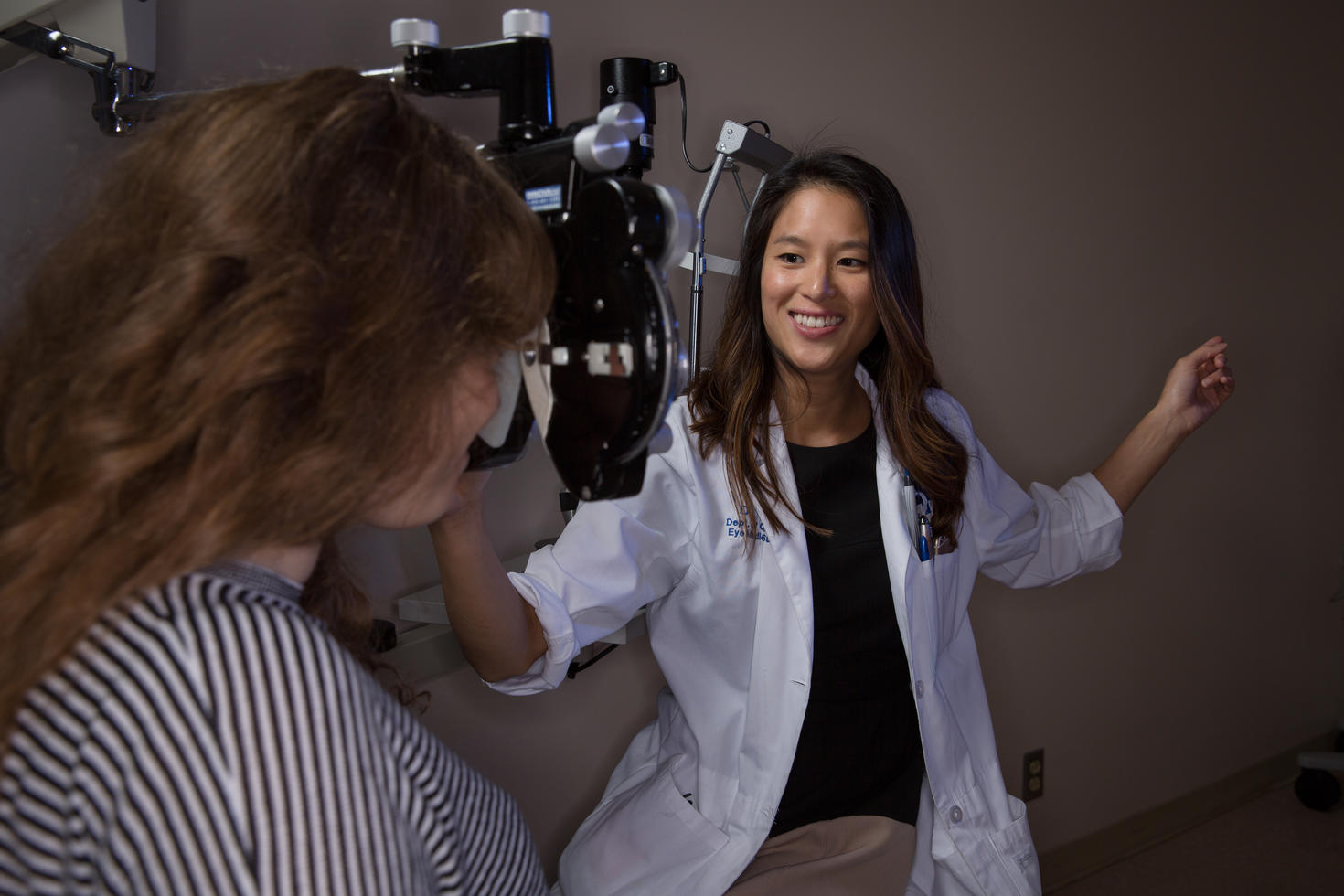 An ophthalmologist about to examine a patient with slit lamp