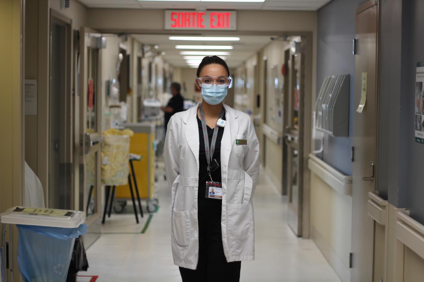 young female pharmacist standing in a hospital hallway