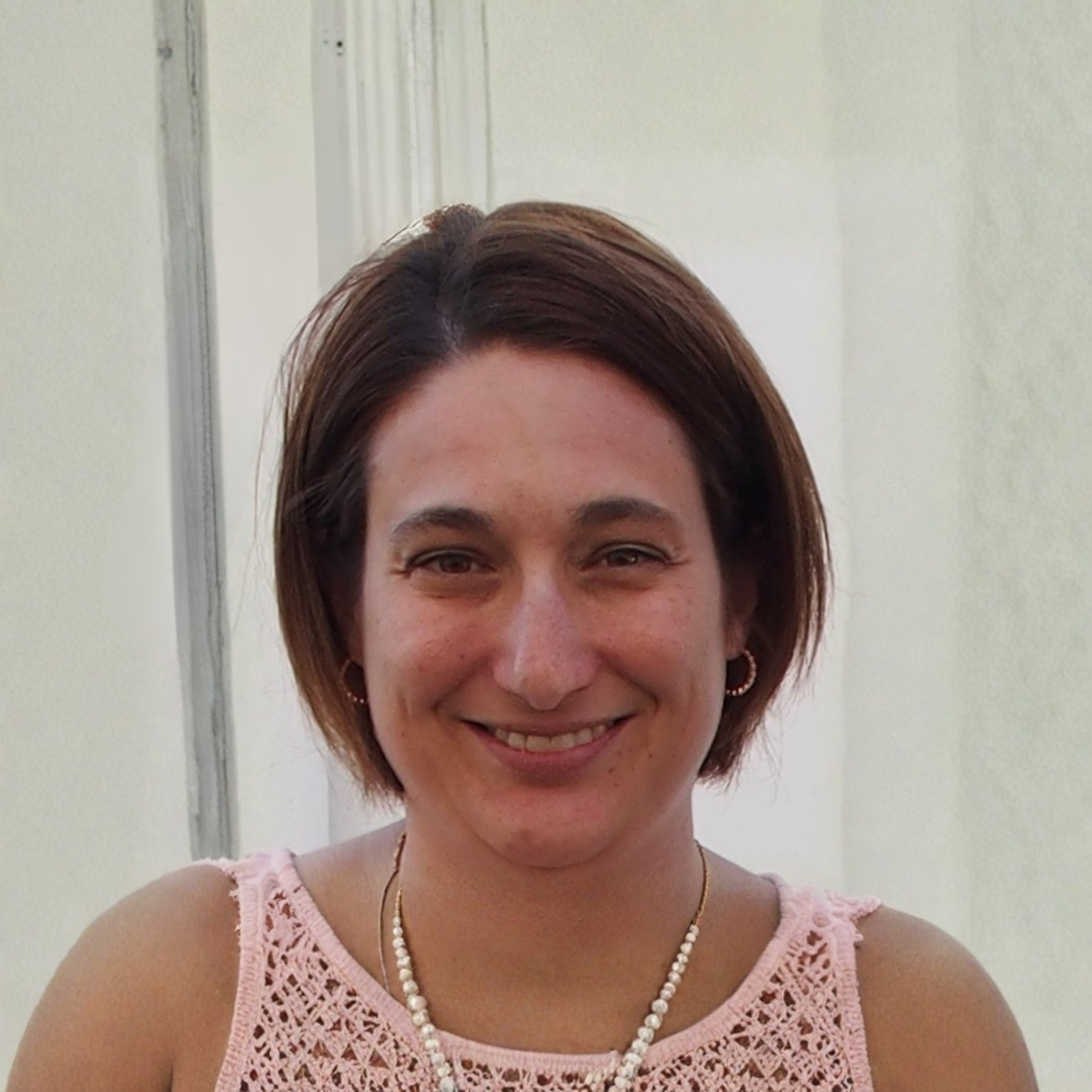 Dre Sylvie Caissie souriant devant un fond blanc