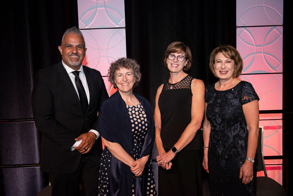 The picture features 4 people posing for a picture at the Induction ceremony.