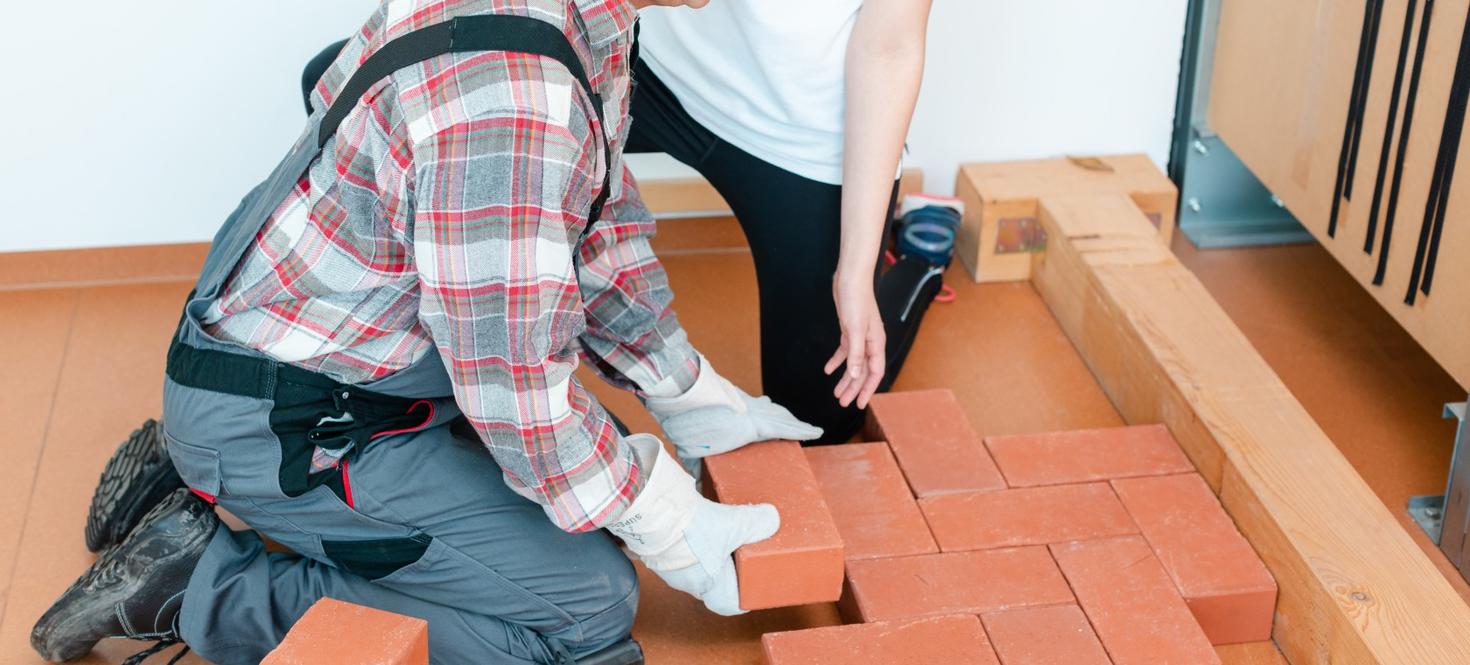 a man placing bricks in a simulated environment