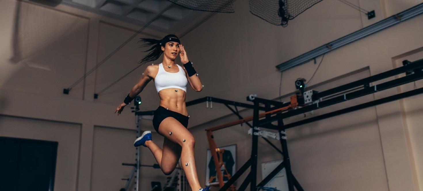 woman running in a lab with sensors on her