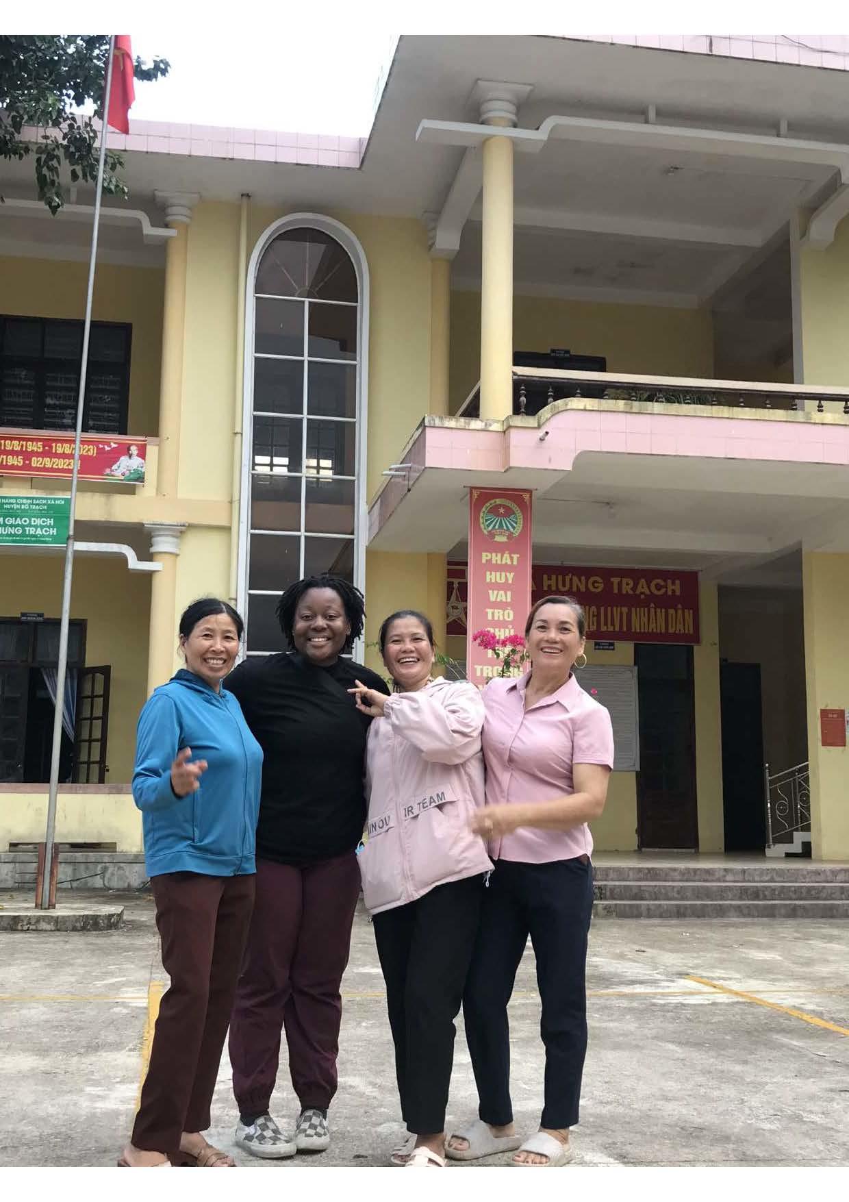 Group of 4 people in front of a vietnamese building