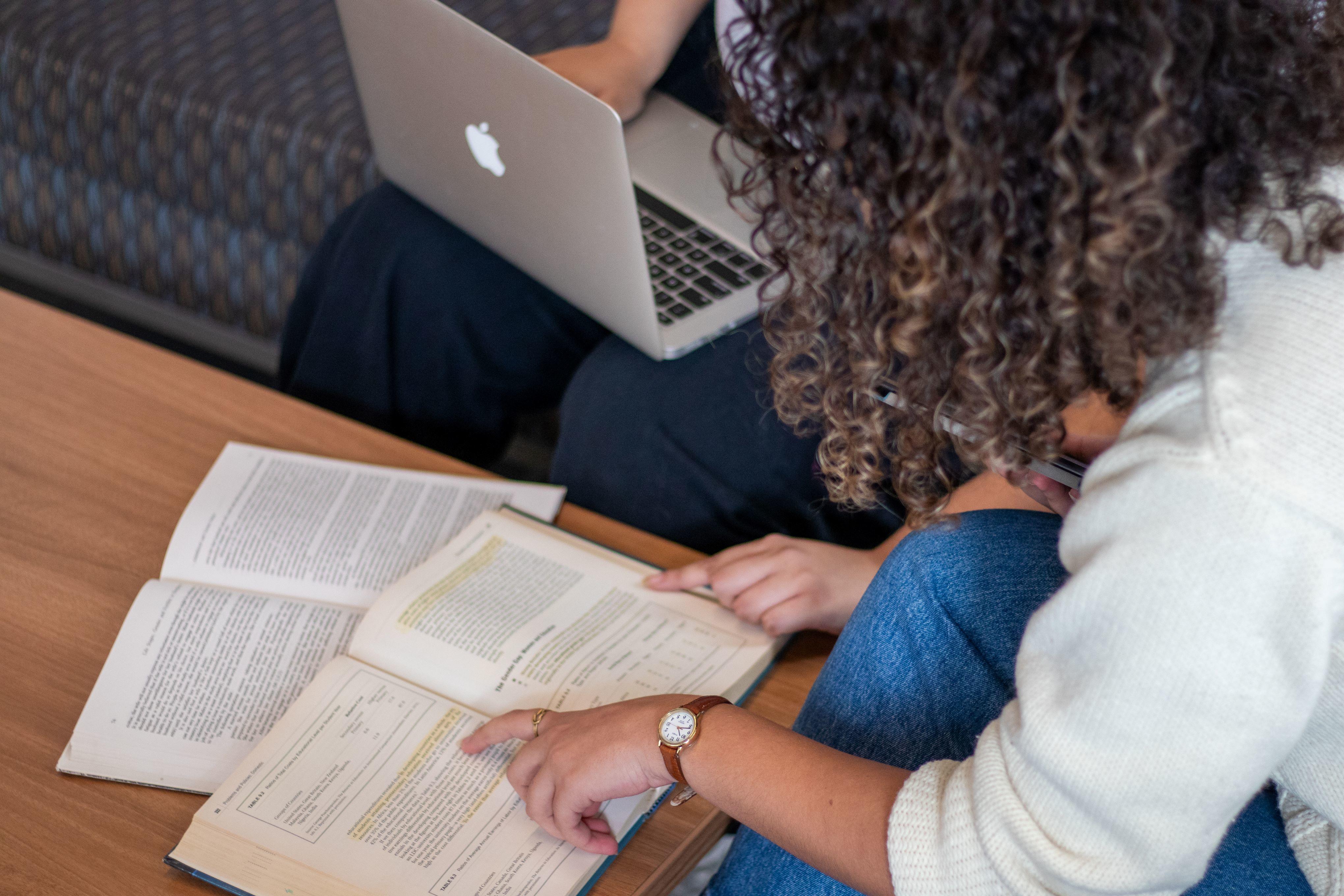 student looking at text in a book