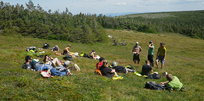 Students lying down in a field.